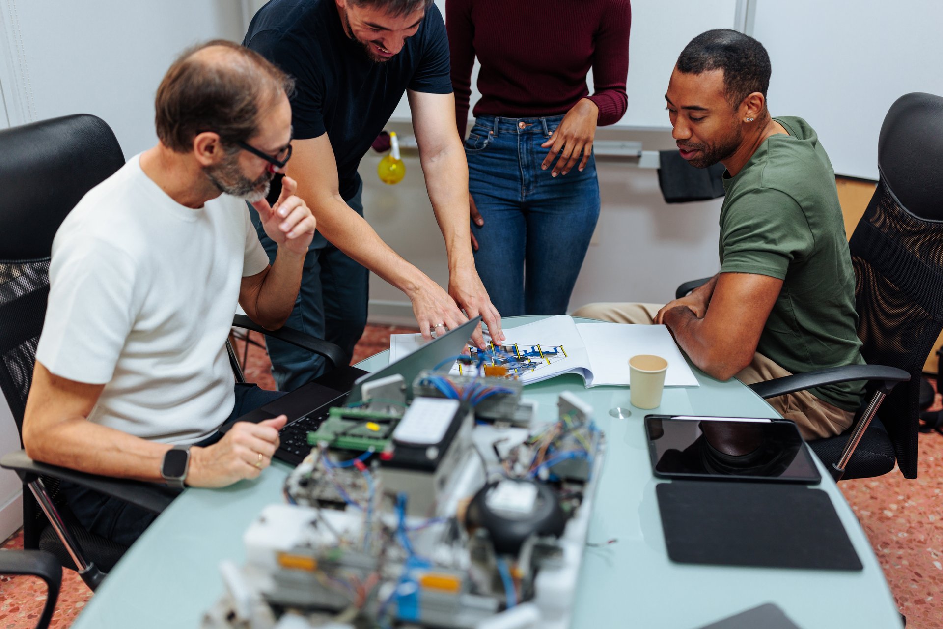 Engineers developing IoT device prototypes in advanced workshop