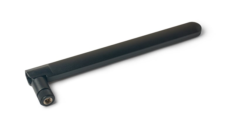 Close-up of black detachable fiber optic wifi router antenna isolated on white background with SMA connector