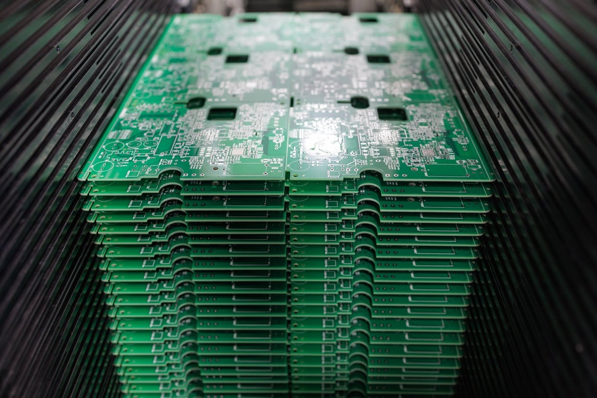 PCB panels stacked in a magazine loader on a high speed SMT line