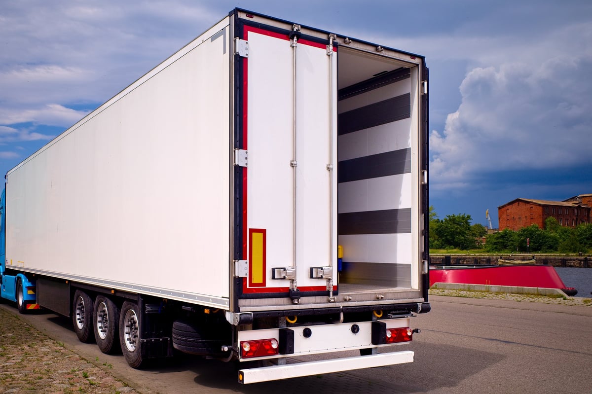 Refrigerated truck trailer at industrial warehouse for cold chain logistics